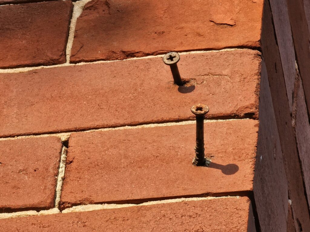 brick is broken off at the location of the screw - fastening