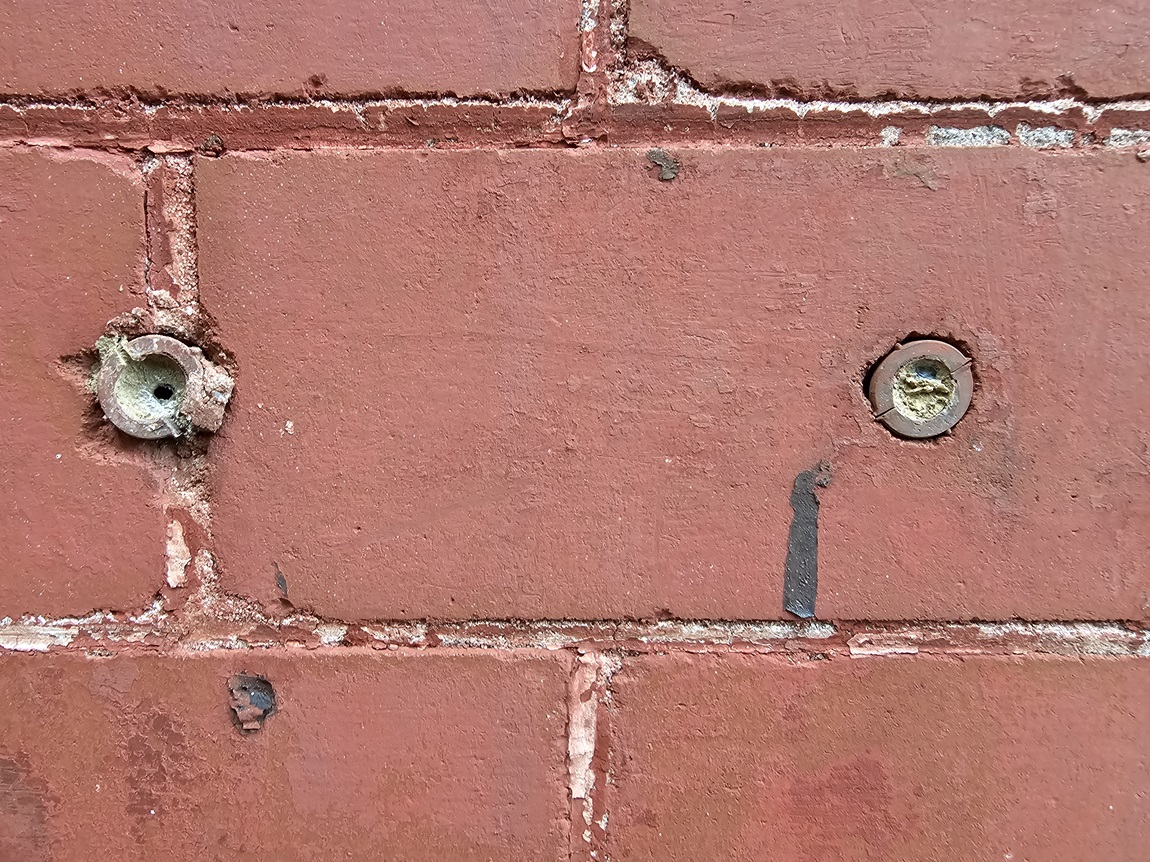 screw-anchors-installed-into-the-face-of-a-historic-brick