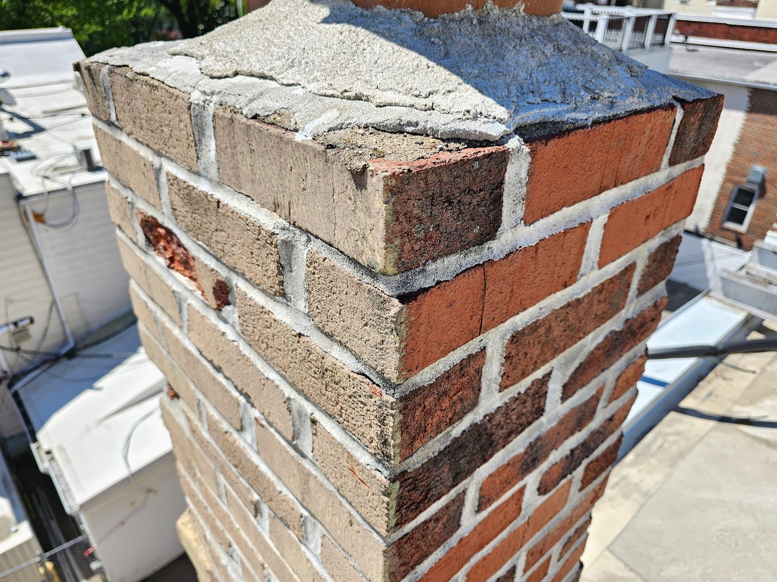 crown or flaunching around the terracotta flue has deteriorated to the point that areas of the horizontal surface