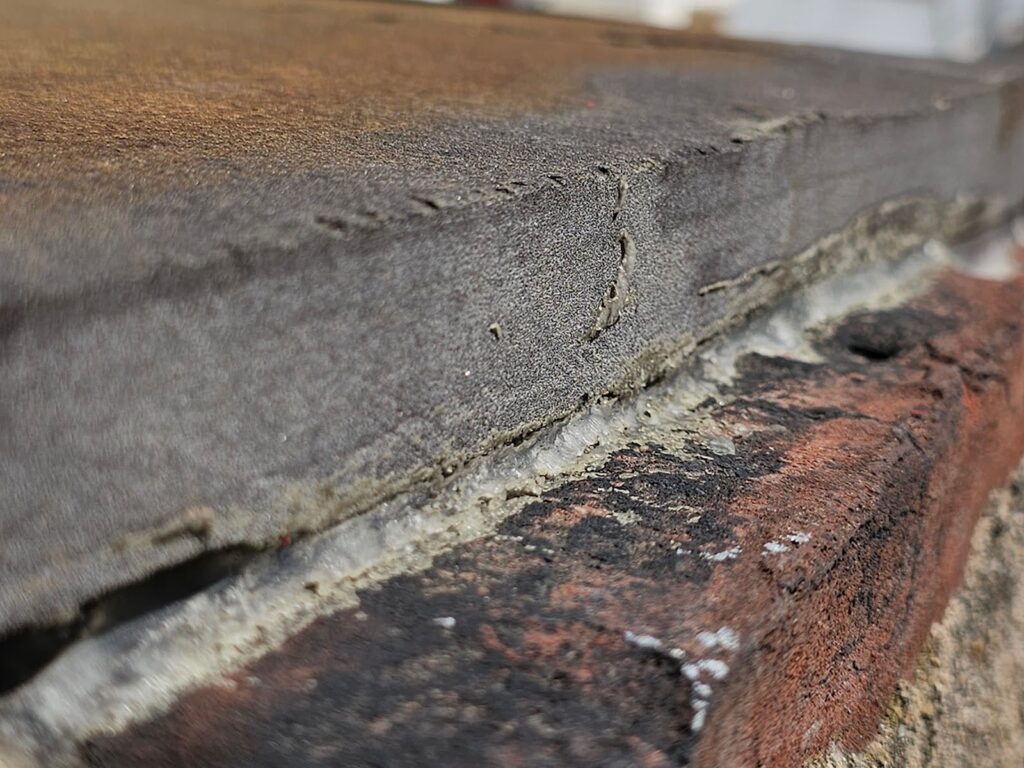 joint between the underside of the stone and the top of the brick
