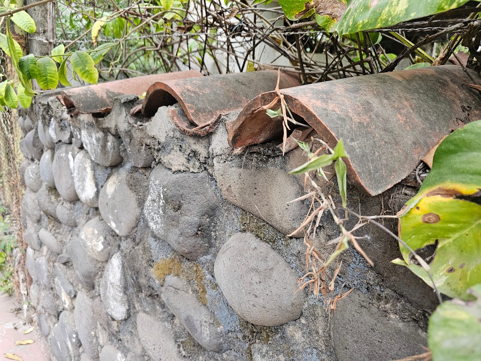 clay tiles that have been laid in an alternating overlap pattern for wall coping