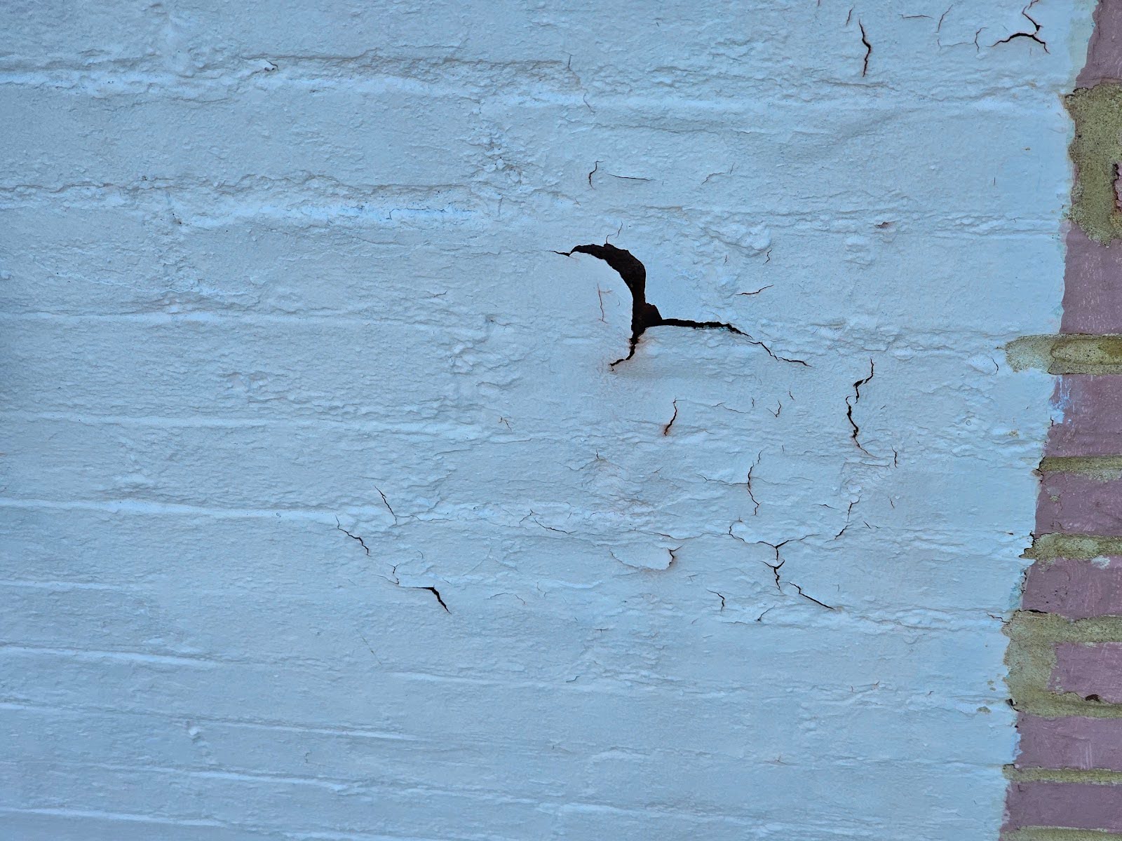 the face of the brick and the separating paint
