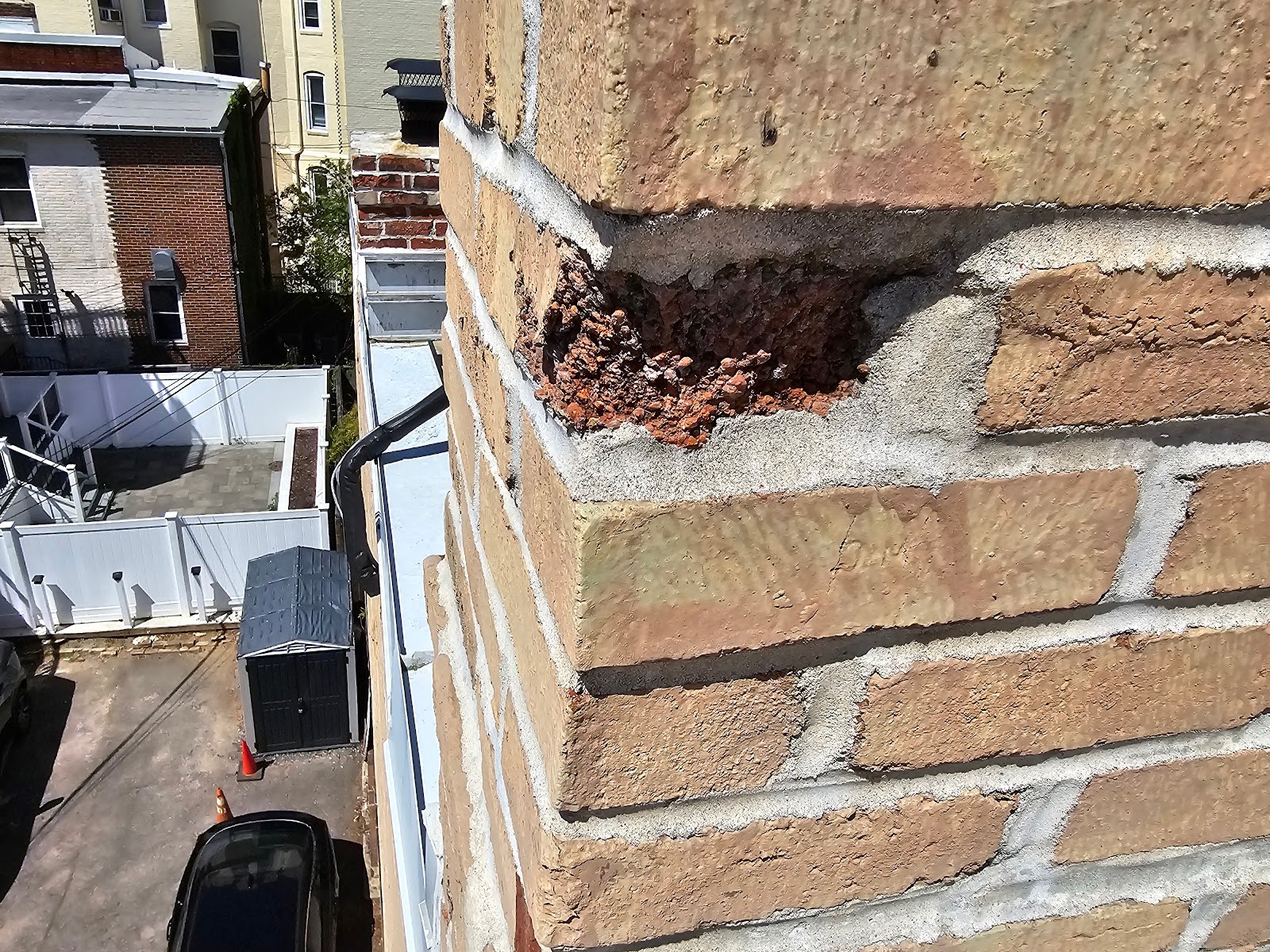 the omission or recess area where the brick spalled away.