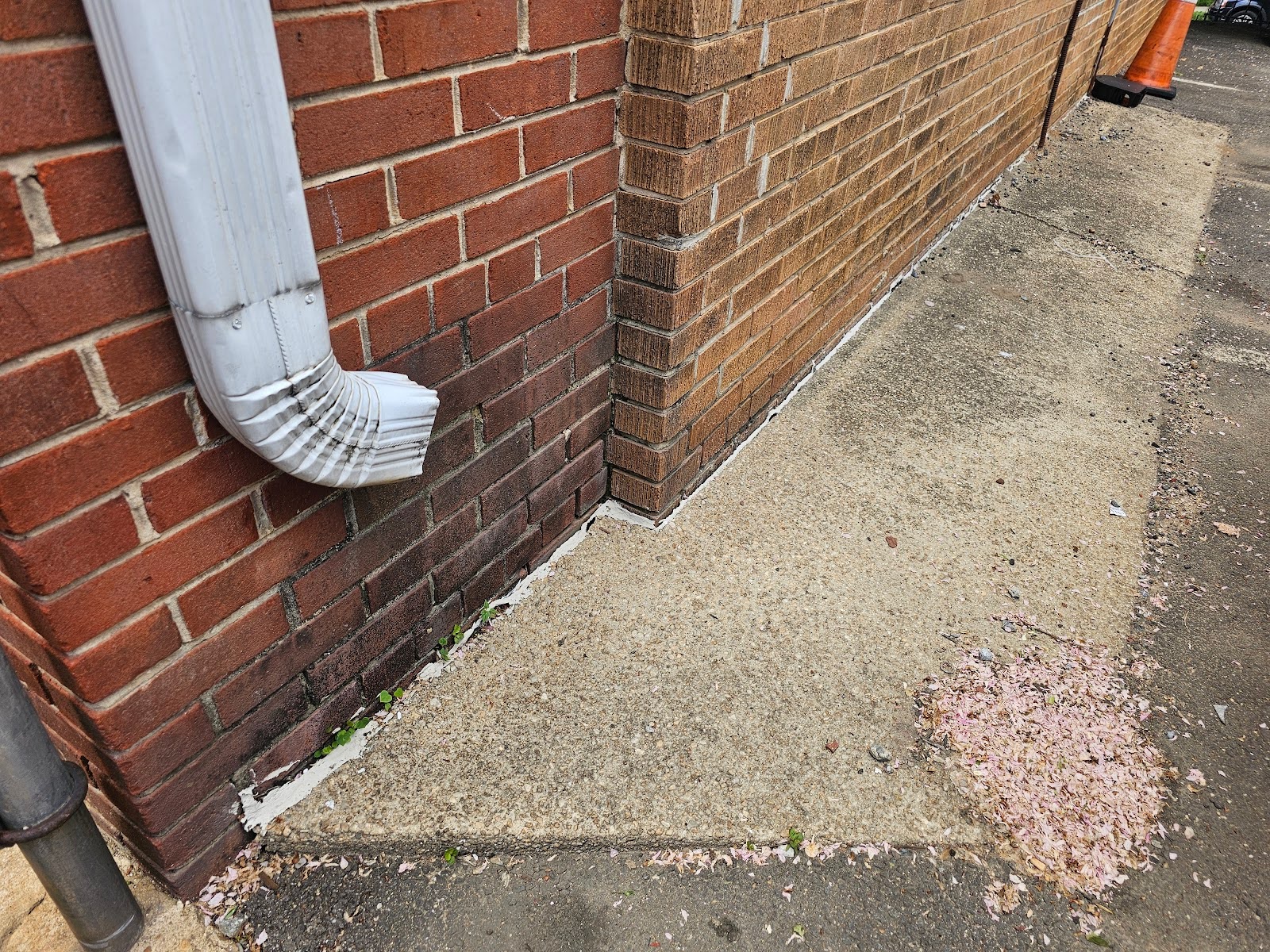 dark gray color on the base of the wall because the downspout
