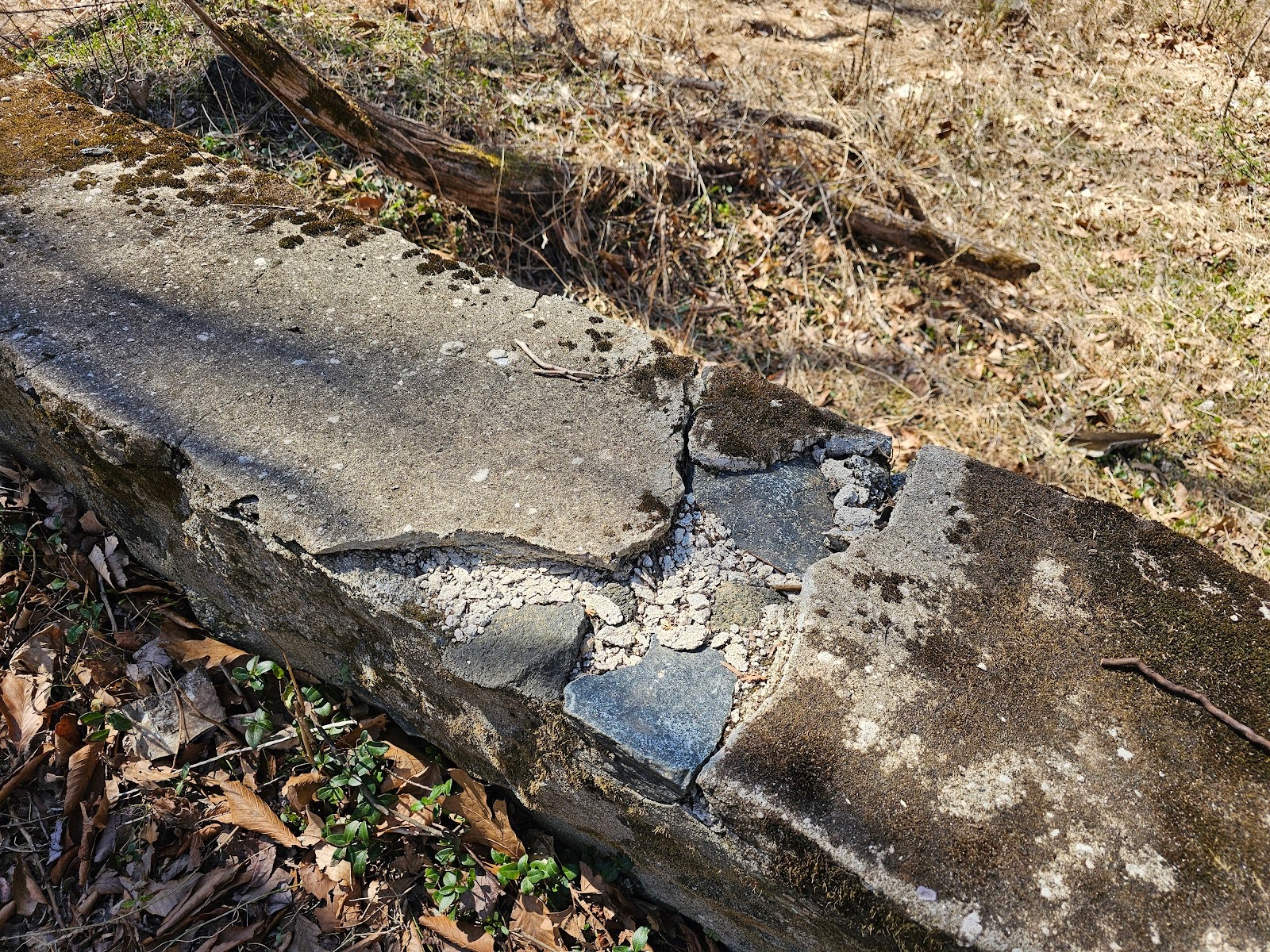 cement cap was applied after the mortar and stone work at the top of the wall started to break down