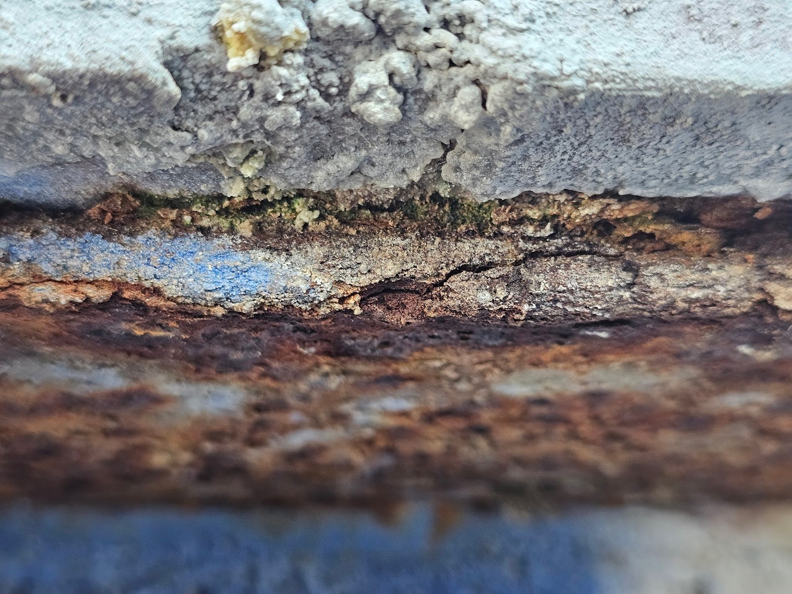 Close-up of masonry deterioration from leaking gutter in DC property