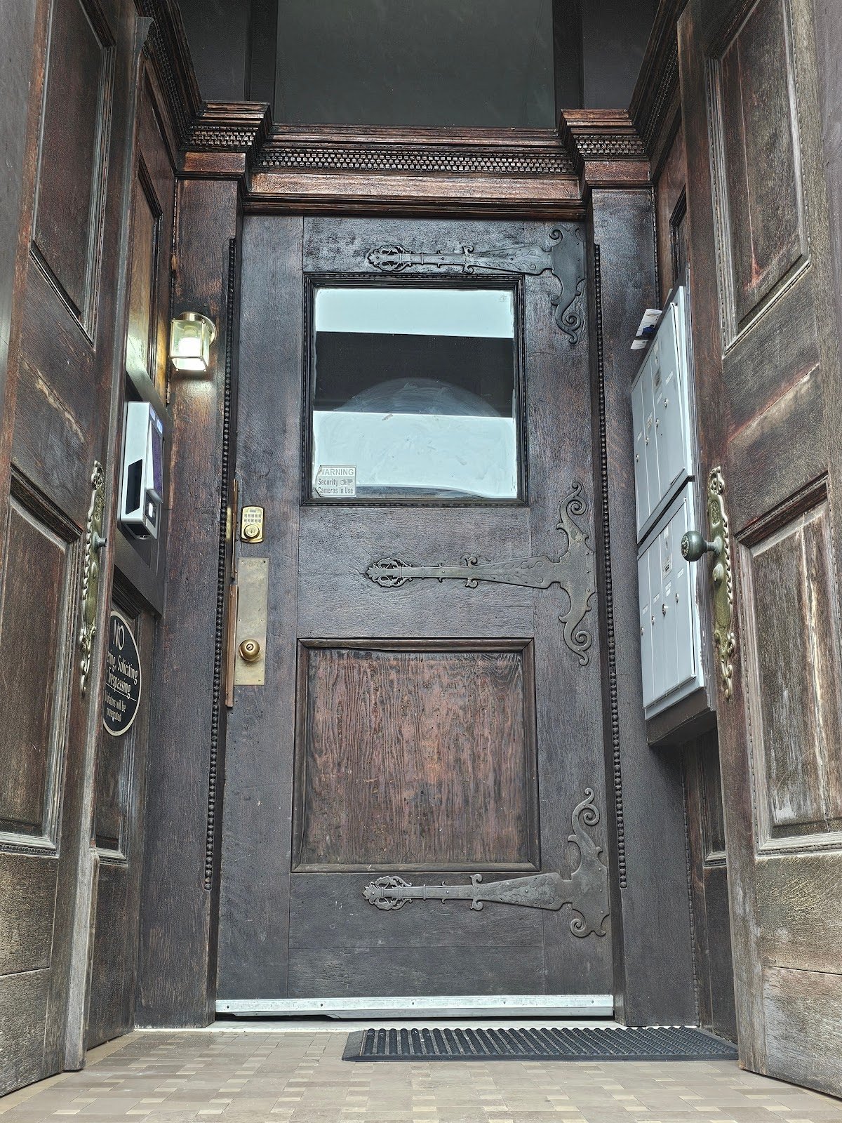Close-up of strap hinges on historic masonry door