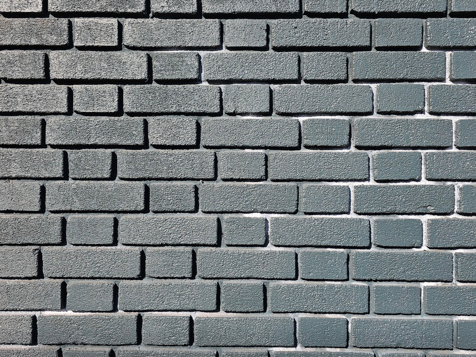Close-up of raked masonry joints in a brick wall