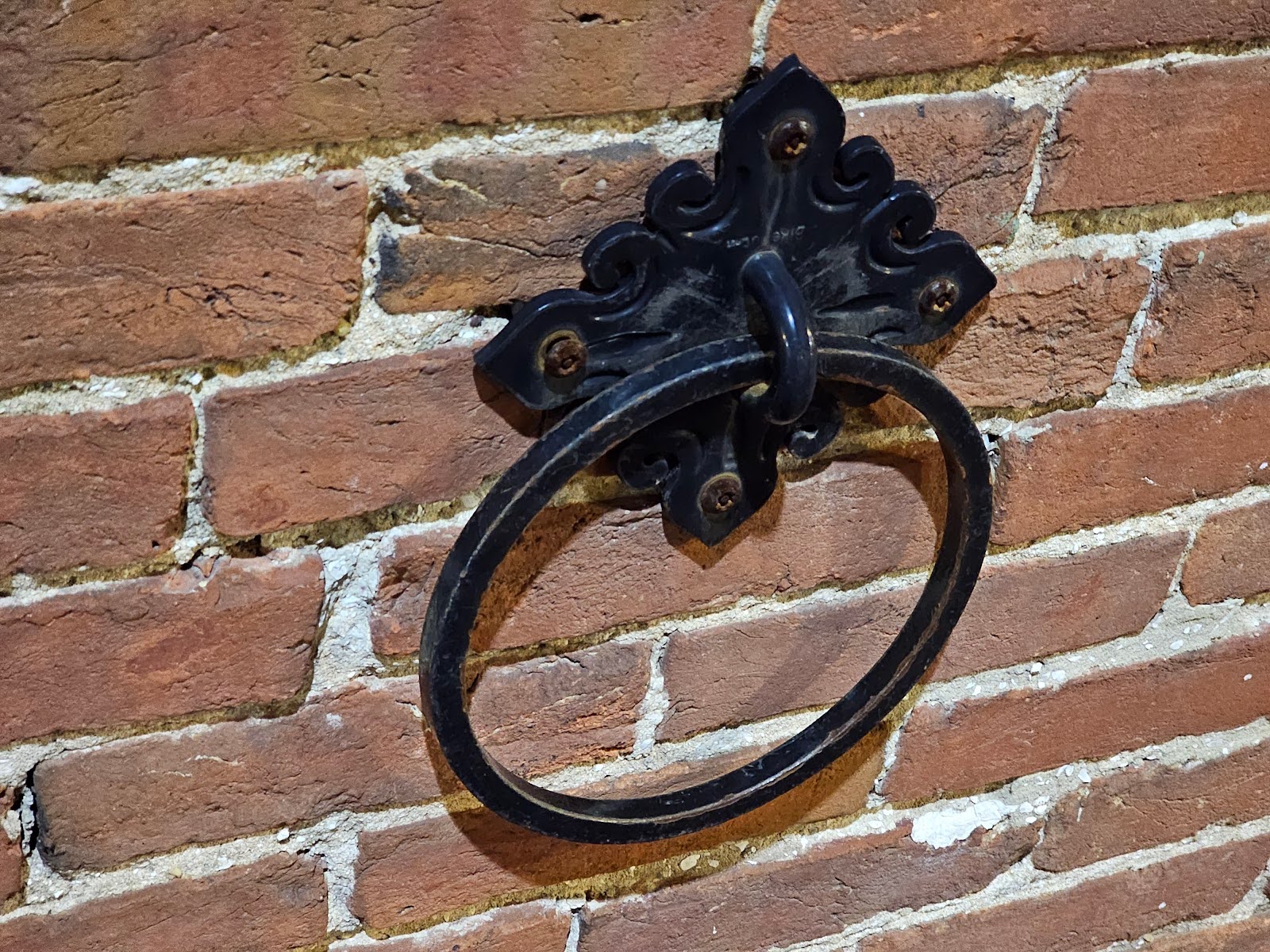 Historic brick wall featuring a metal Horse Binding Ring
