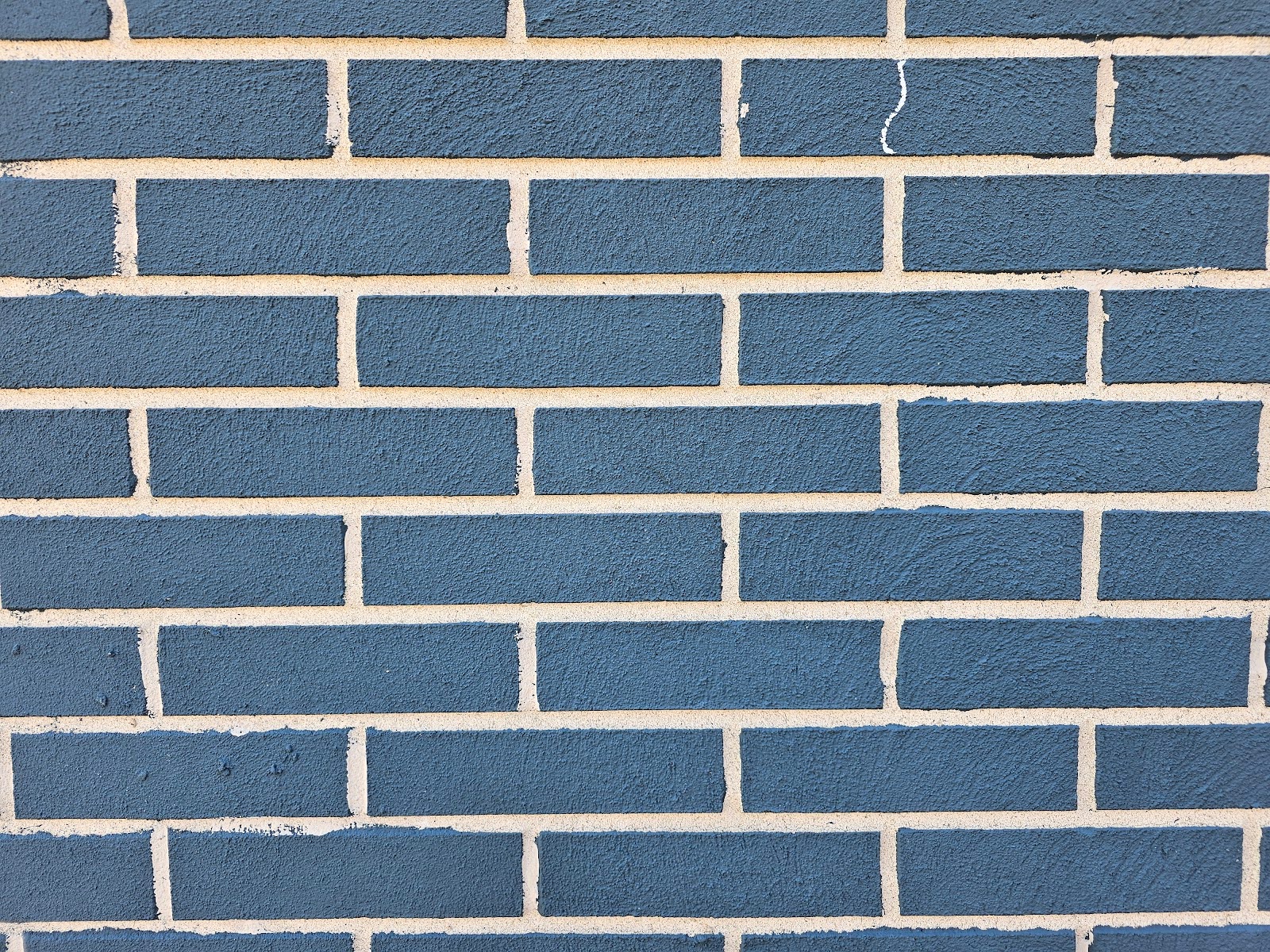 Painted Brick Faces with unpainted mortar joints close-up view