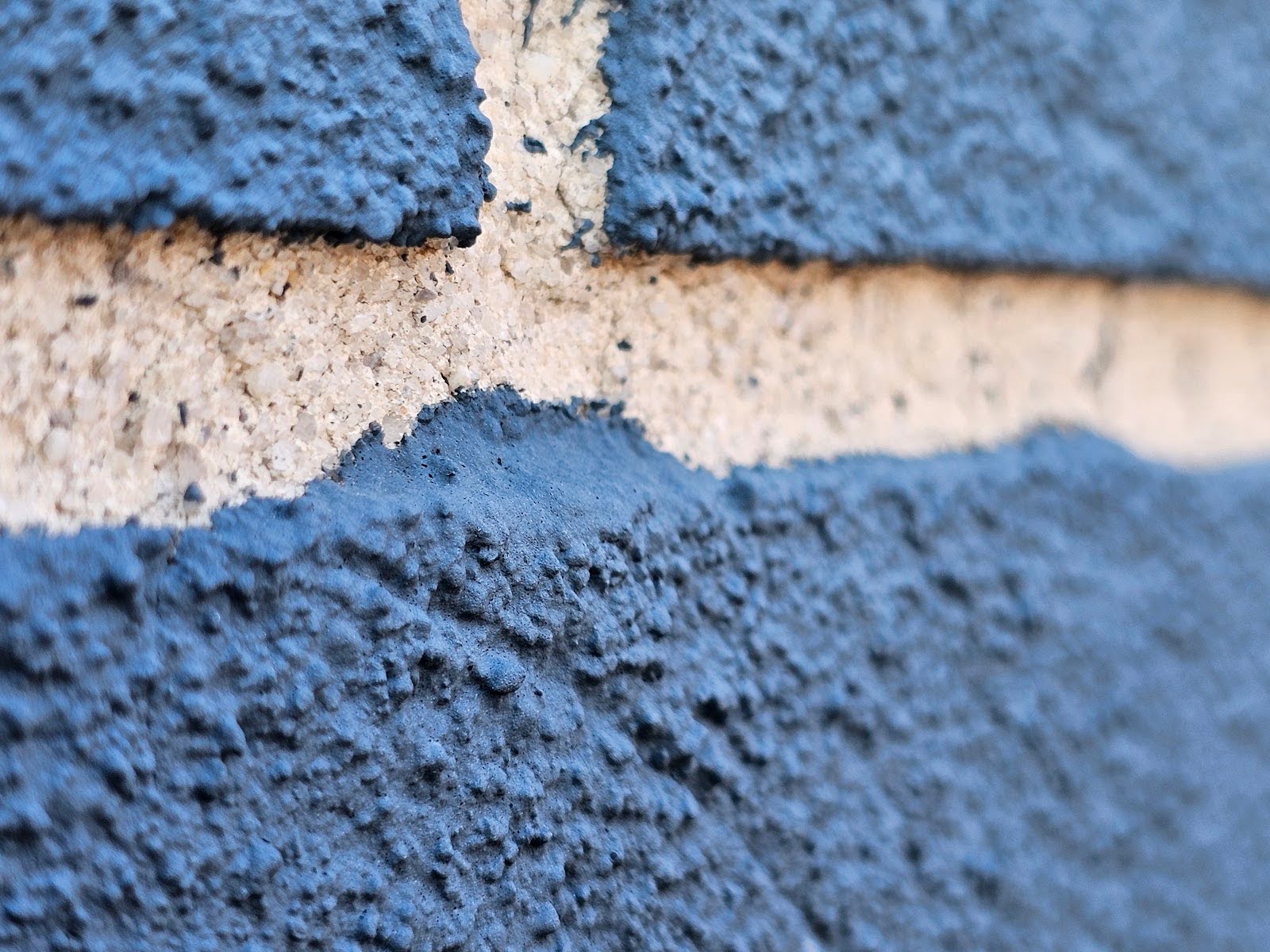 Side elevation view of building featuring Painted Brick Faces and unpainted mortar joints