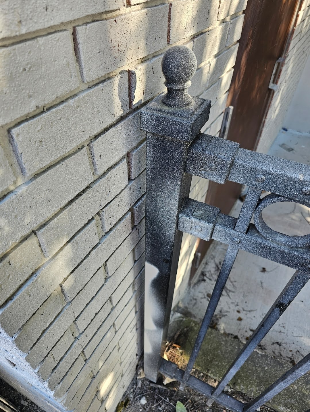Completed painted brick facade showing clean lines after masking removal