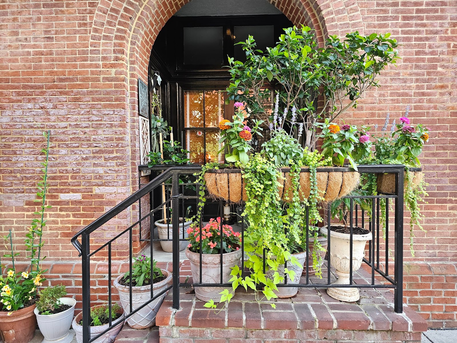 Hanging planters used as exterior brick wall decorations
