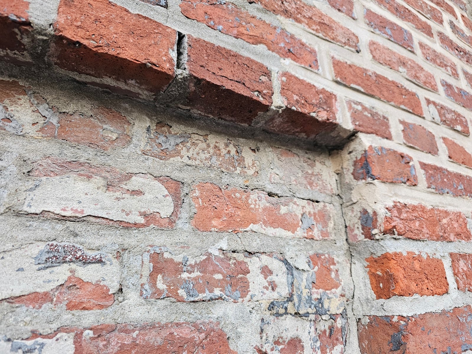 Thin cement parge coat on top of the face of the brick