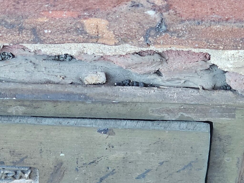 access panel has been sealed to the masonry substrate with a sealant