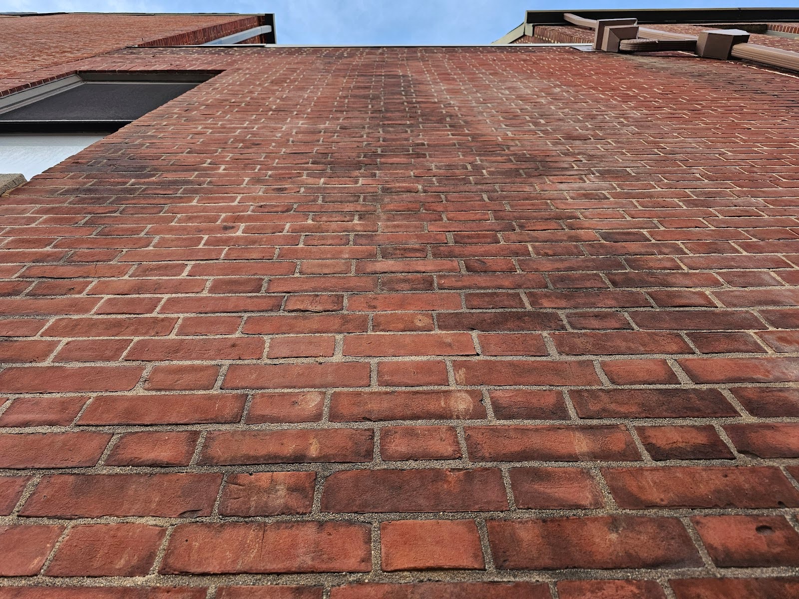 concentrated trails of water running down the brick facade
