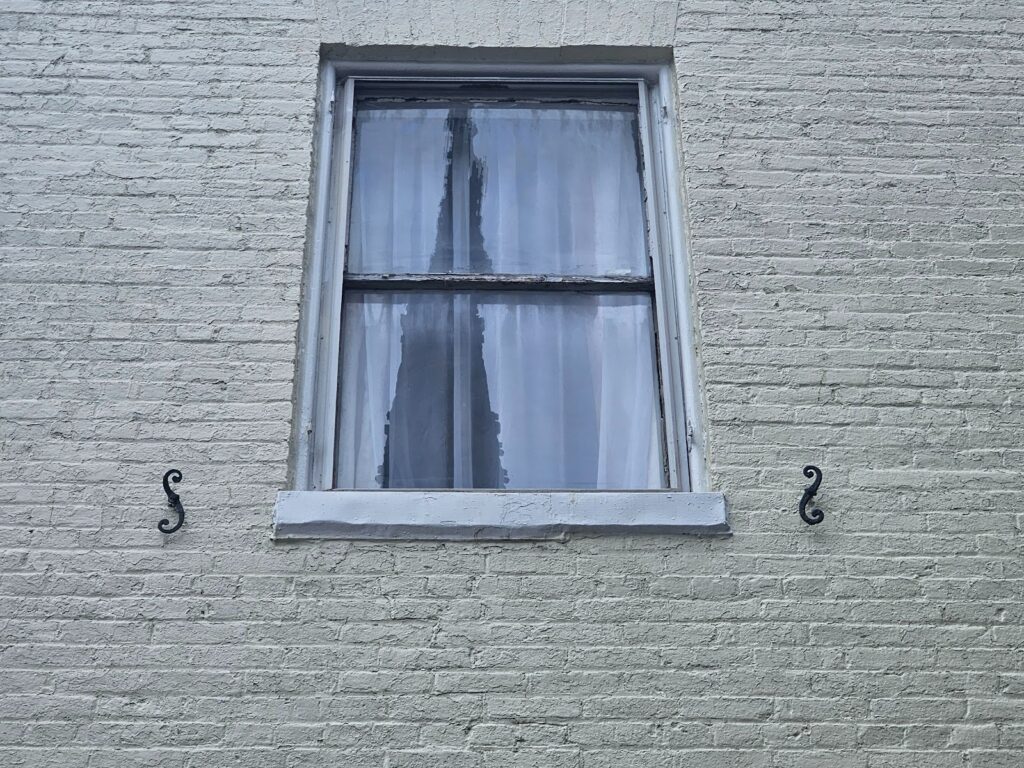  two shutter dogs left at the sides of an original windowsill