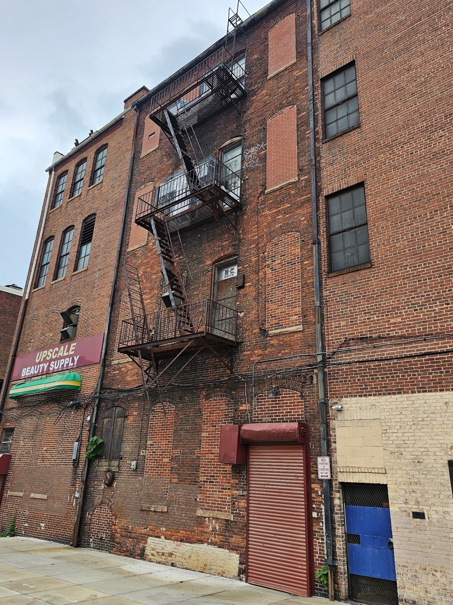 Aging iron rooftop access path requiring inspection and maintenance for safe roof access