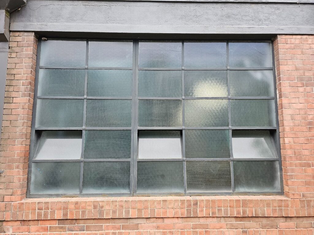 Historic brick building featuring newly installed industrial-style window system
