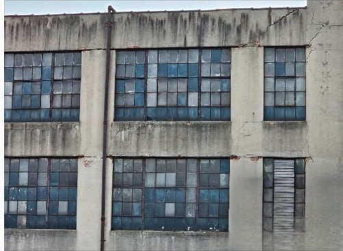 Industrial steel window installed within a historic brick wall opening during restoration project