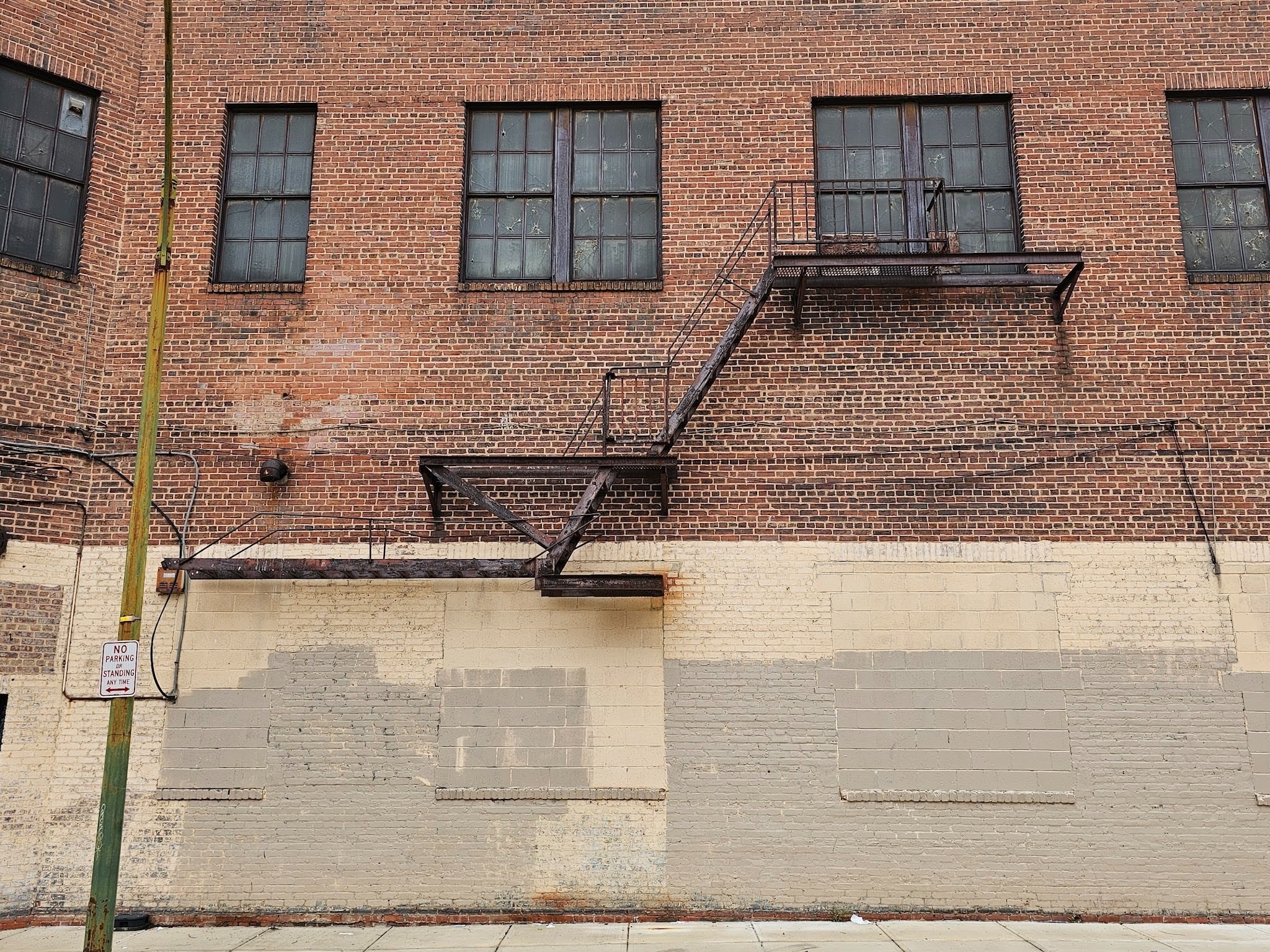 Old iron access and egress paths showing weathered metal walkways on a commercial roof