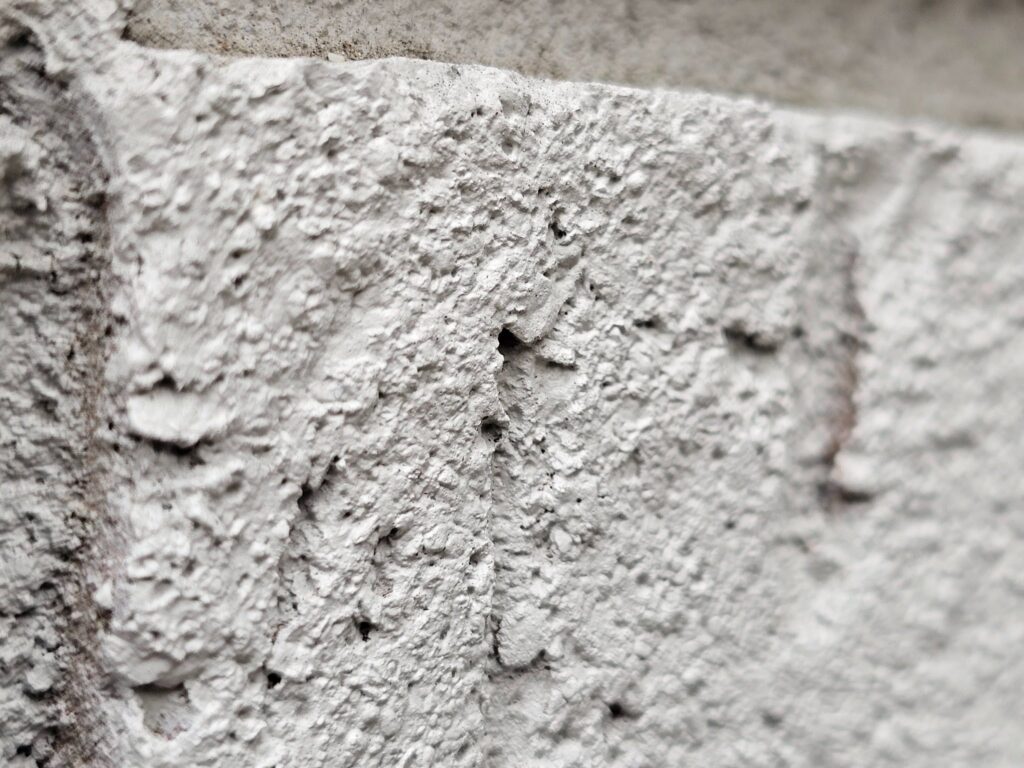 Close-up of metal flashing protecting a brick and concrete block connection on a Washington, DC building
