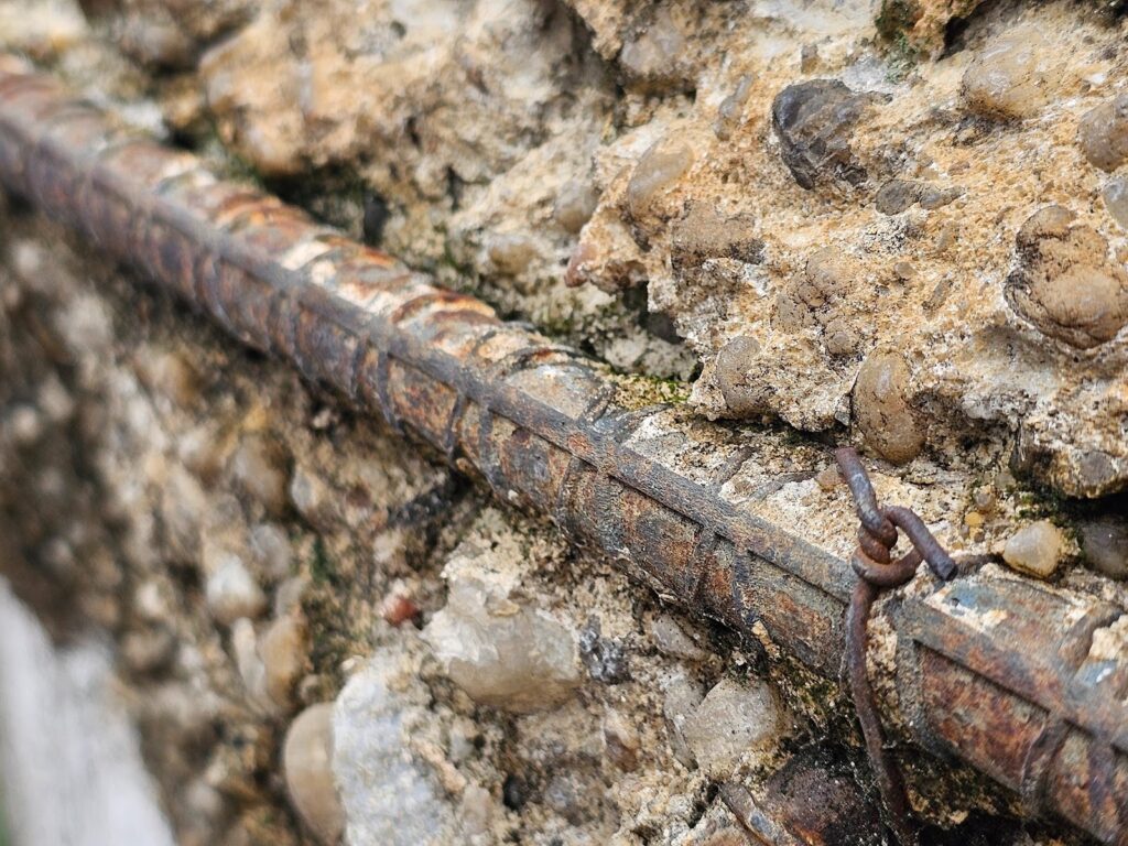 Close-up view of concrete deterioration caused by excess water and hydration