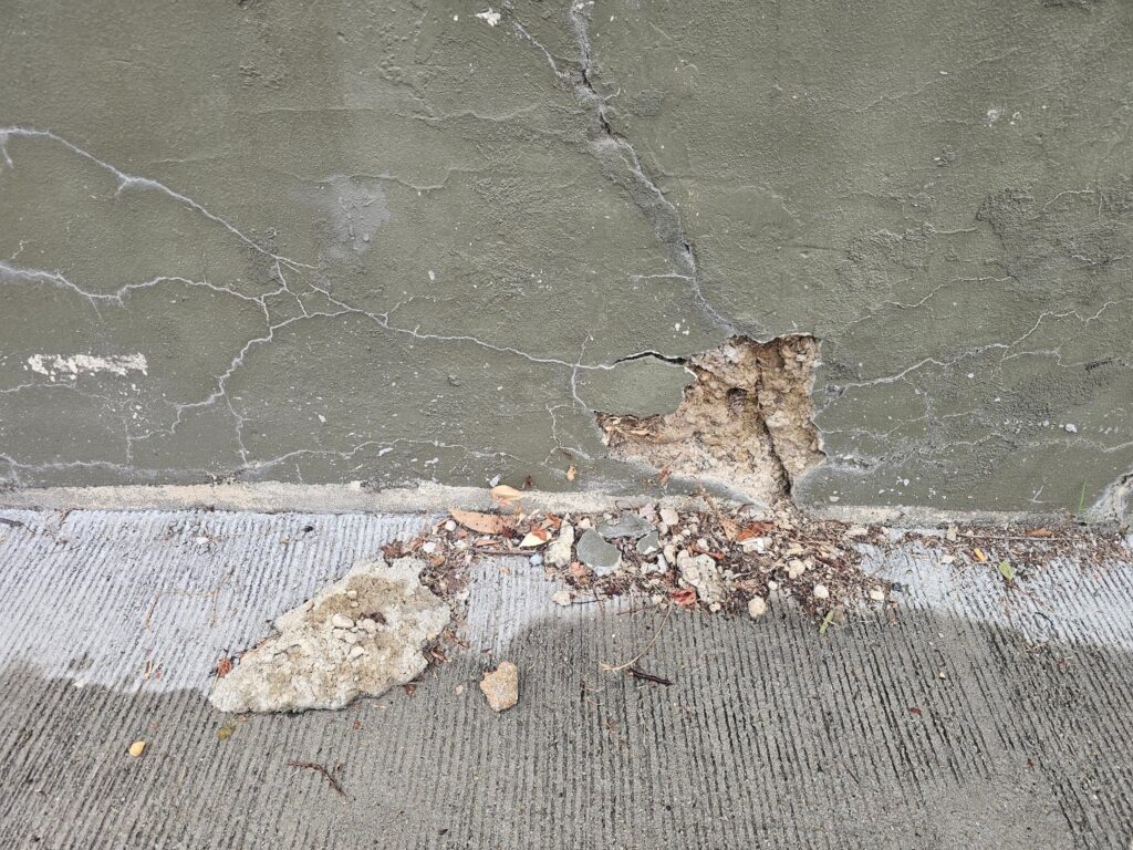 Cracked retaining wall showing signs of deterioration and failure