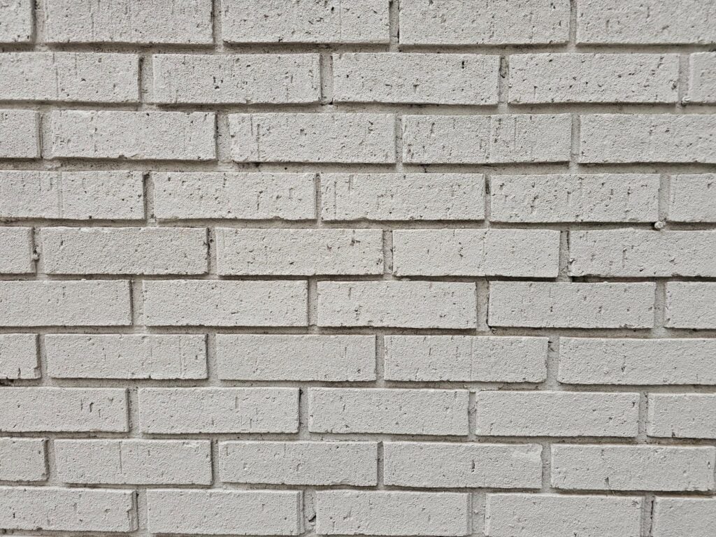 Historic Washington, DC masonry wall featuring metal flashing at the brick and block junction