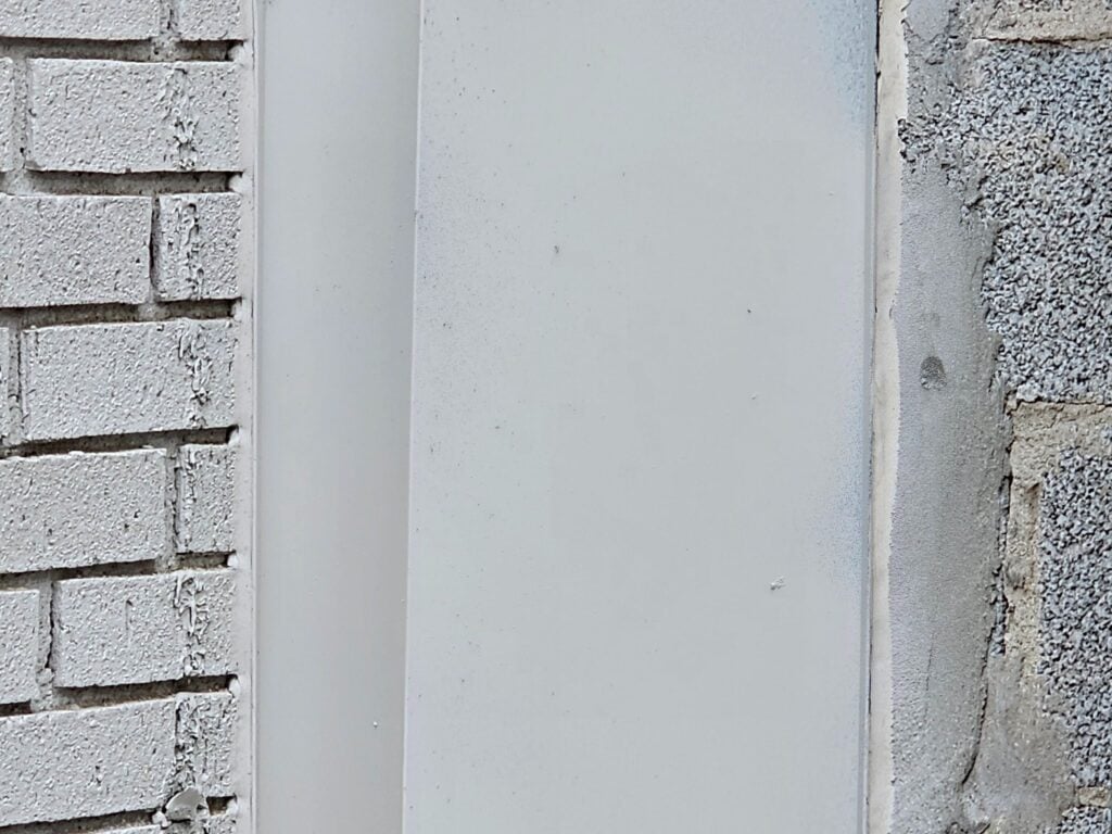 Metal flashing installed at a brick to block wall union during masonry restoration in Washington, DC