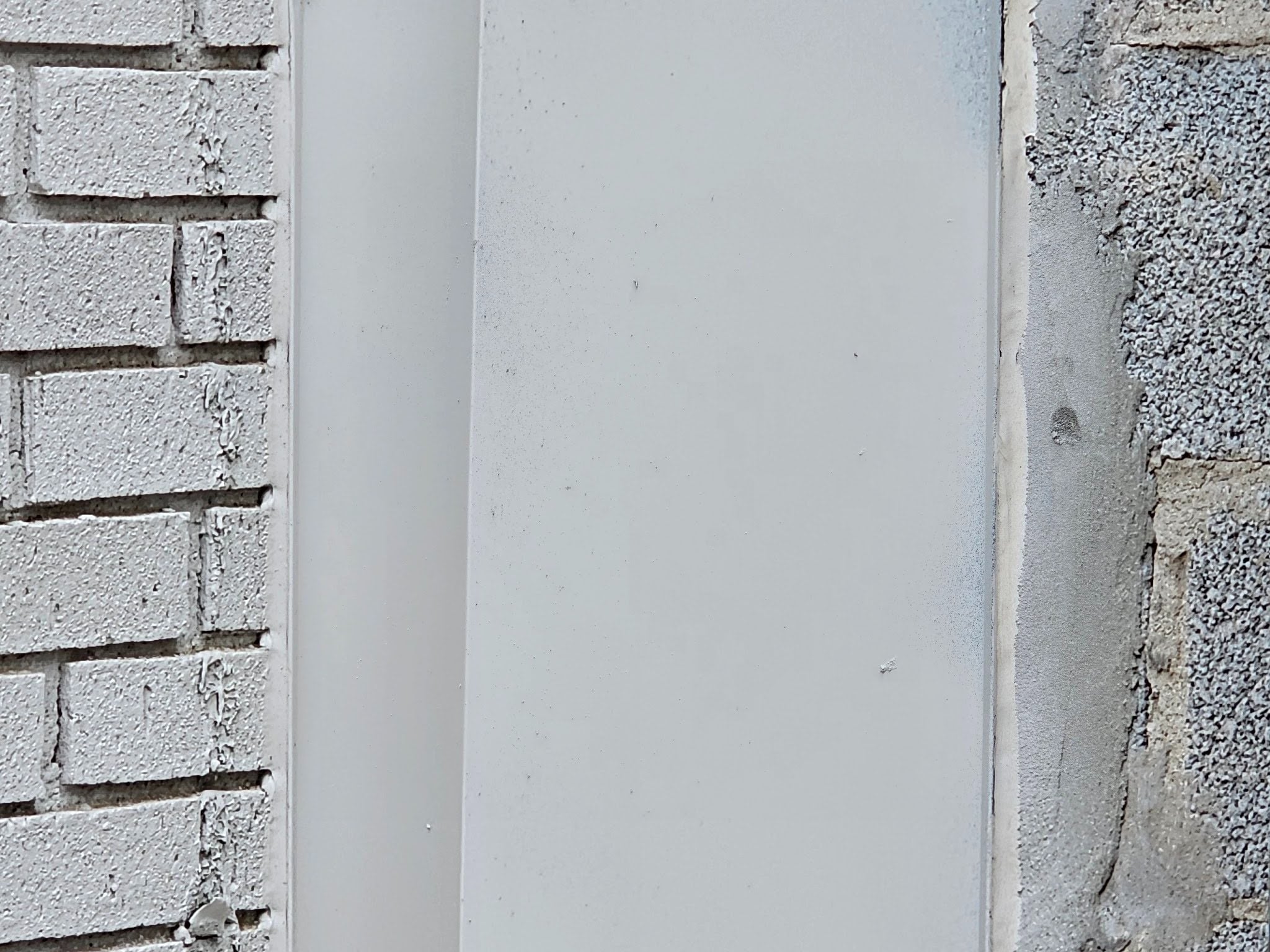 Metal flashing installed at a brick to block wall union during masonry restoration in Washington, DC