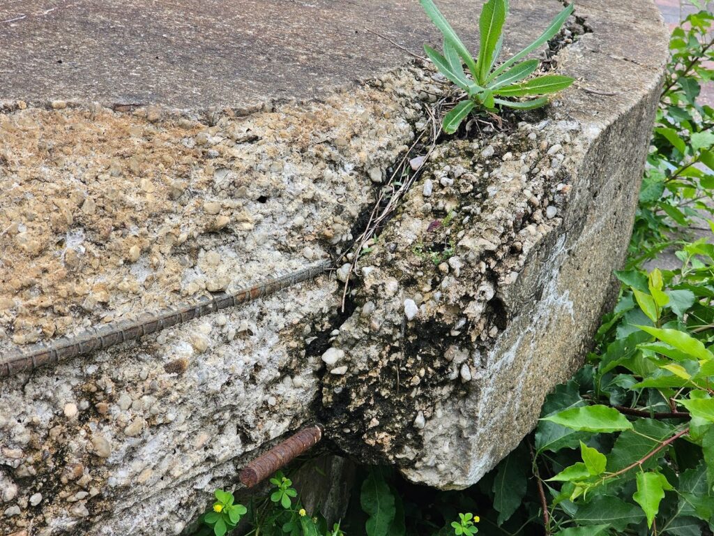 Overhydrated concrete surface displaying signs of material breakdown and deterioration