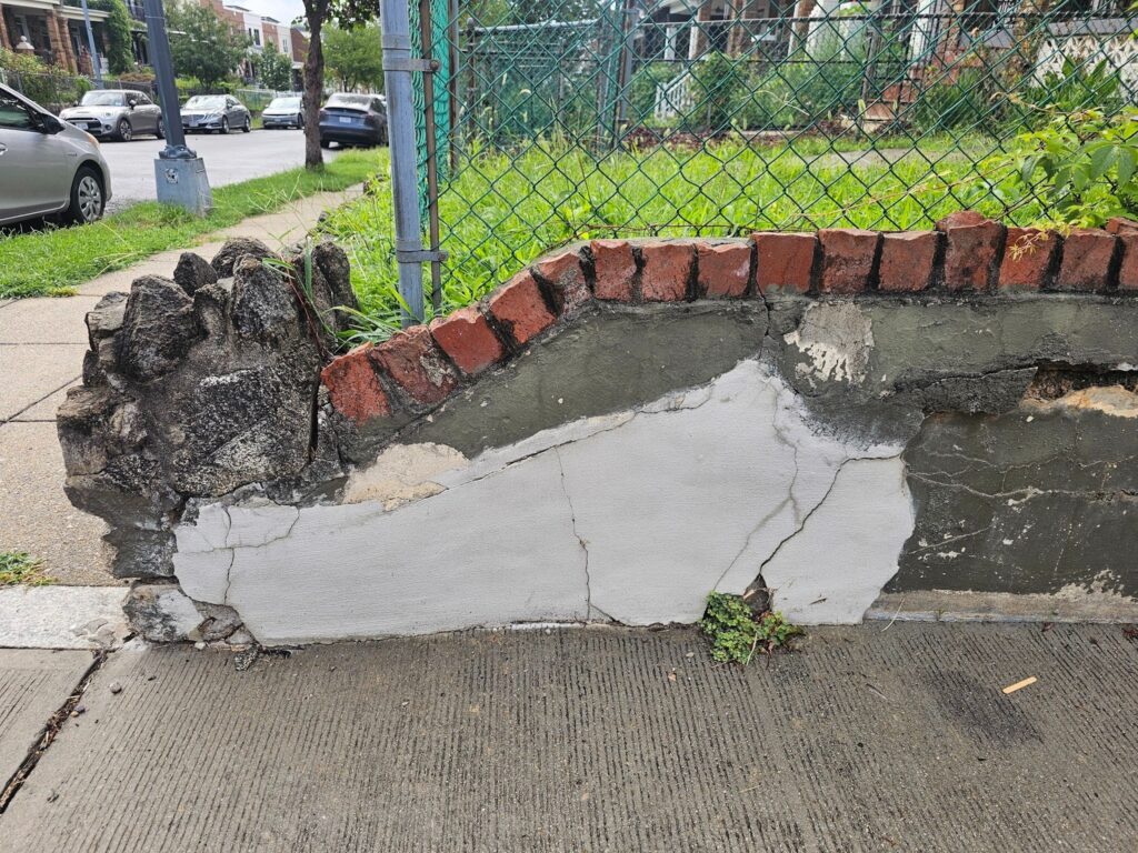 Signs of structural damage indicating a retaining wall needs to be rebuilt